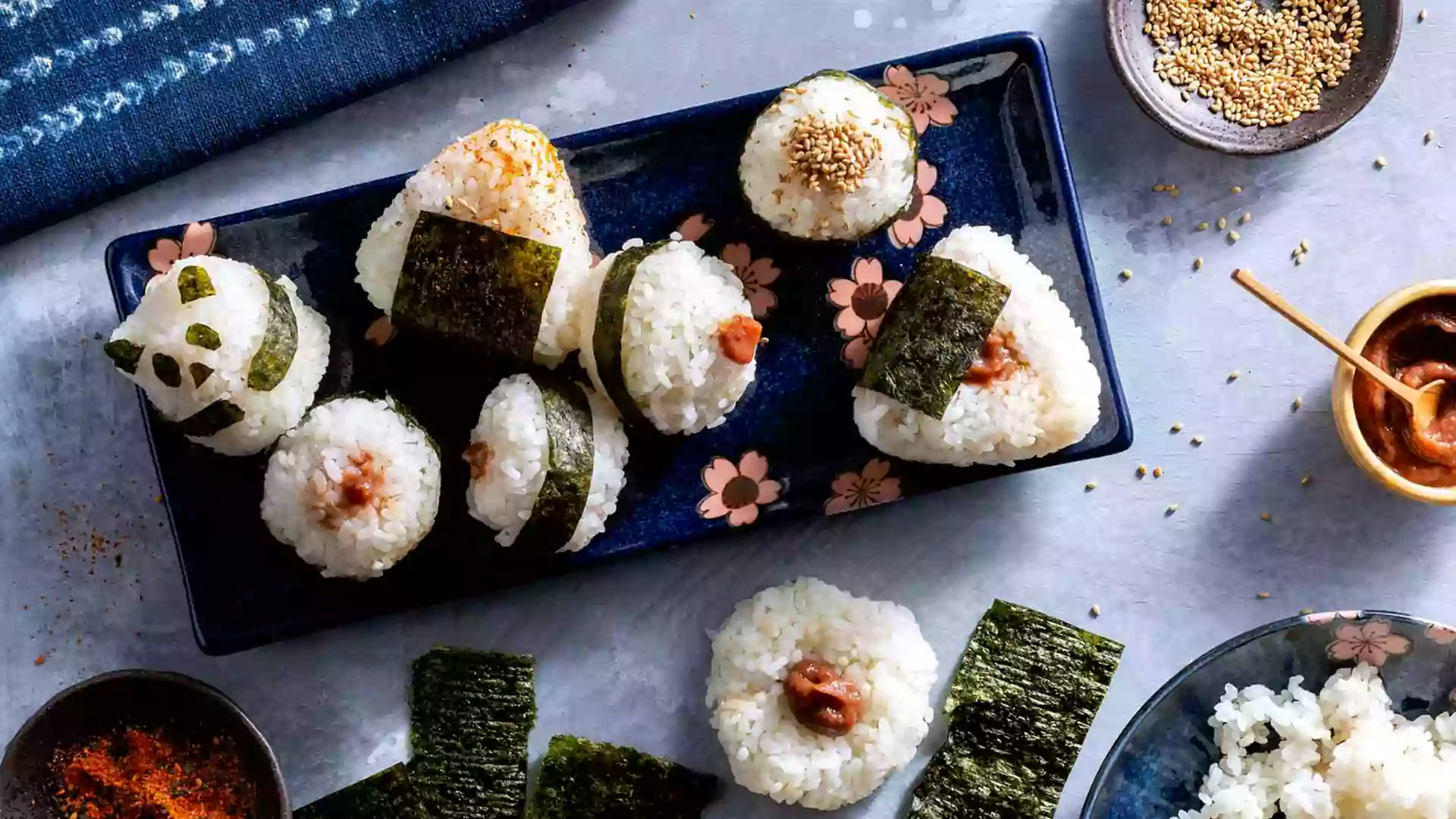 Onigiri makanan khas Jepang berbentuk nasi kepal dengan nori dan isian beragam, camilan praktis populer dalam kuliner Jepang sehari-hari.